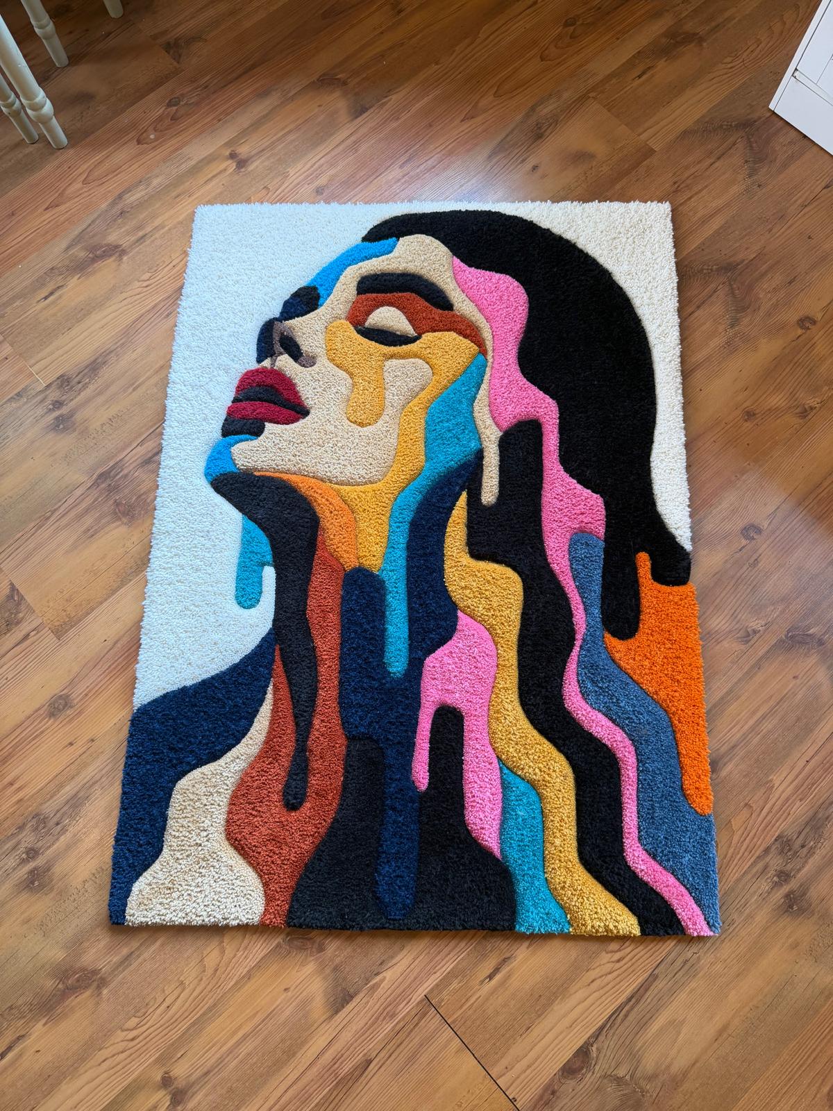 Melting portrait rug photographed from a distance on a wood floor