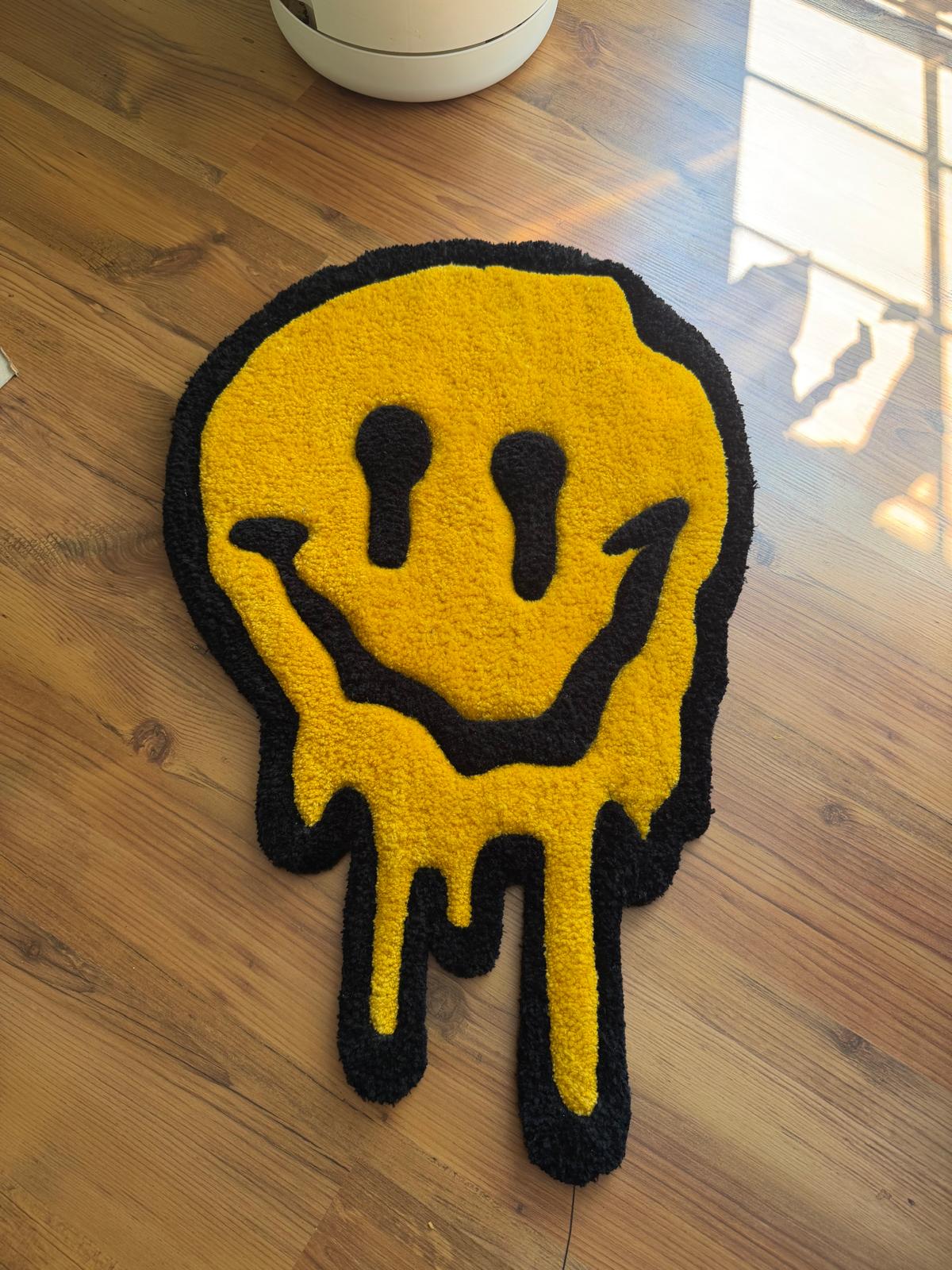 Hand-tufted melting smiley face rug in yellow and black on a wood floor
